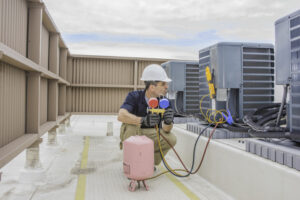 commercial contractor working HVAC system